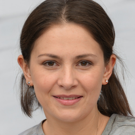 Joyful white young-adult female with medium  brown hair and brown eyes