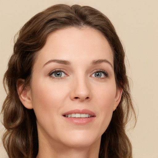 Joyful white young-adult female with long  brown hair and green eyes