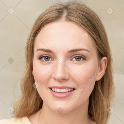 Joyful white young-adult female with long  brown hair and green eyes