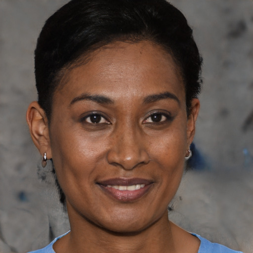 Joyful black adult female with short  black hair and brown eyes