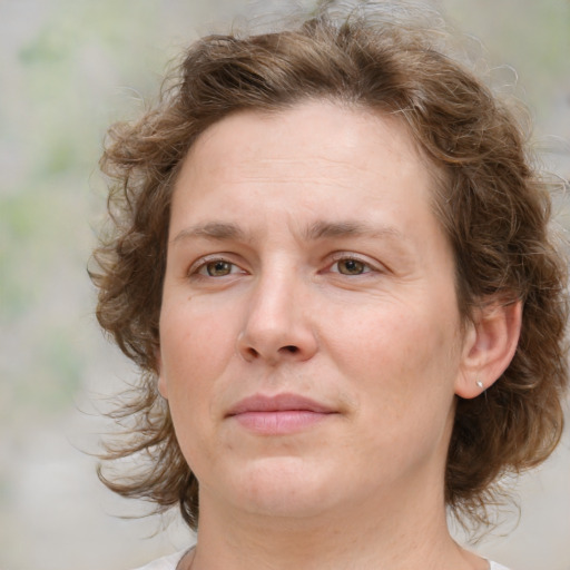 Joyful white young-adult female with medium  brown hair and green eyes