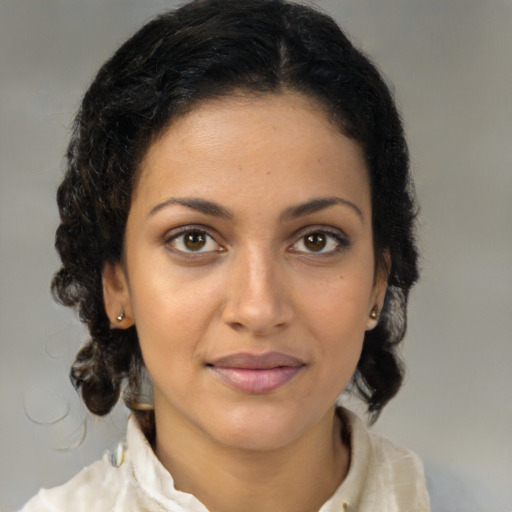 Joyful latino young-adult female with medium  brown hair and brown eyes