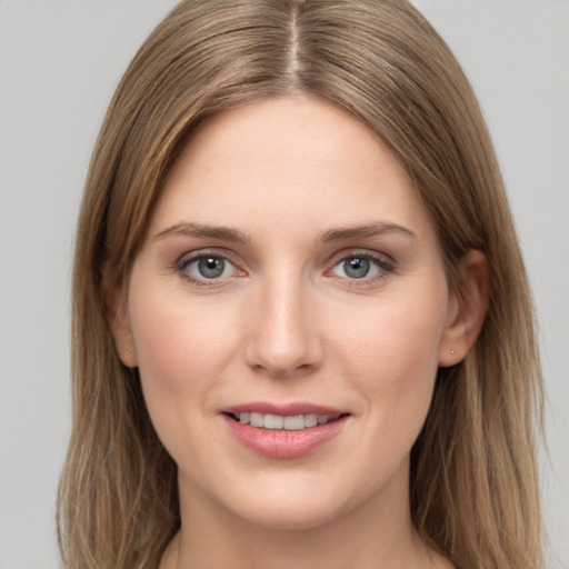 Joyful white young-adult female with long  brown hair and grey eyes