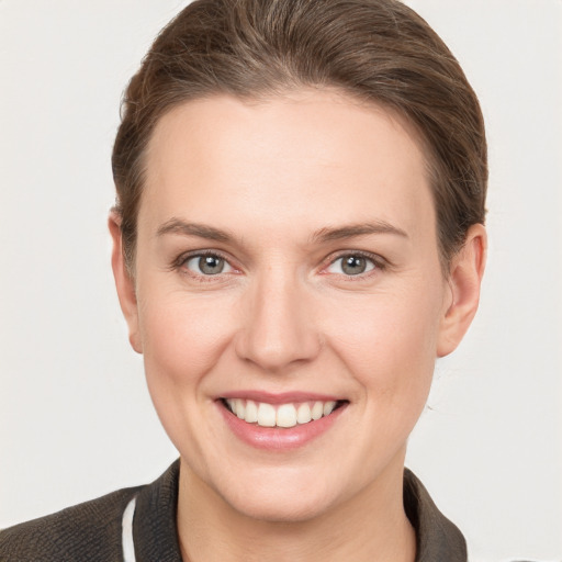 Joyful white young-adult female with short  brown hair and grey eyes