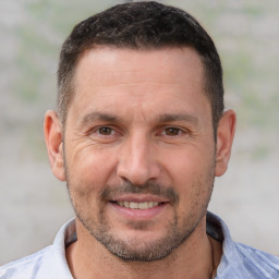 Joyful white adult male with short  brown hair and brown eyes