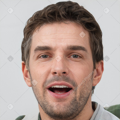 Joyful white adult male with short  brown hair and grey eyes