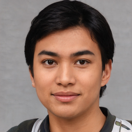 Joyful asian young-adult male with short  black hair and brown eyes