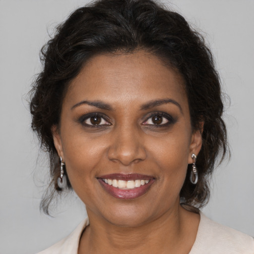 Joyful black young-adult female with medium  brown hair and brown eyes