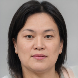 Joyful asian adult female with medium  brown hair and brown eyes