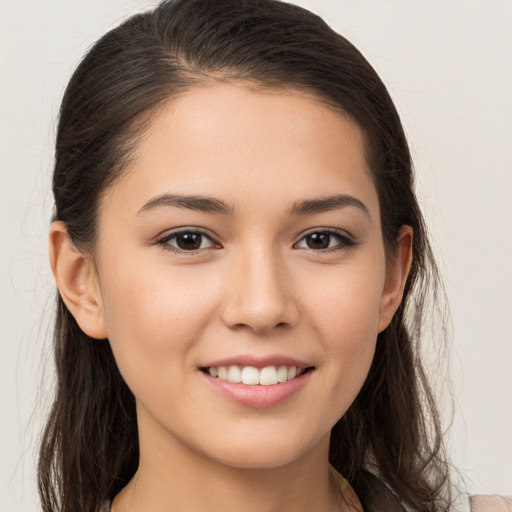 Joyful white young-adult female with long  brown hair and brown eyes