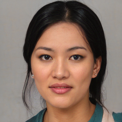 Joyful asian young-adult female with medium  black hair and brown eyes