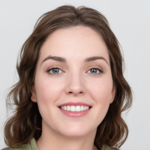 Joyful white young-adult female with medium  brown hair and grey eyes