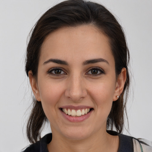 Joyful white young-adult female with medium  brown hair and brown eyes