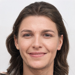 Joyful white young-adult female with long  brown hair and grey eyes