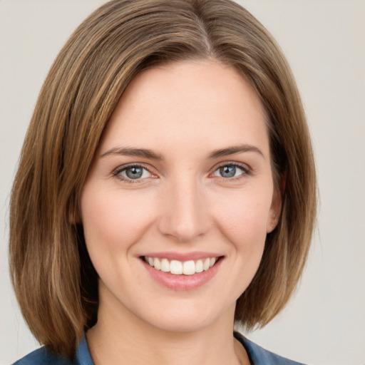 Joyful white young-adult female with medium  brown hair and grey eyes