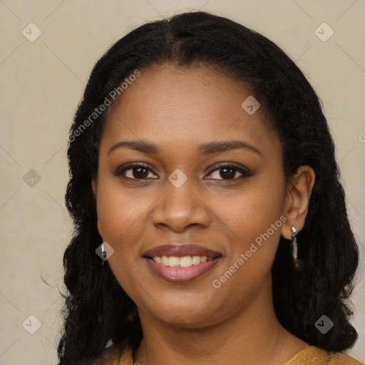 Joyful black young-adult female with long  black hair and brown eyes