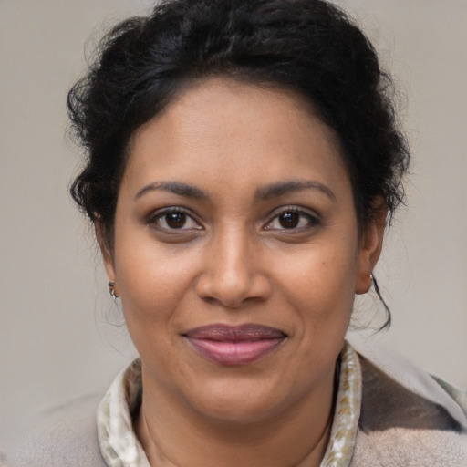 Joyful latino adult female with short  brown hair and brown eyes