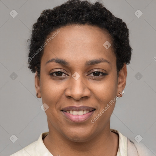 Joyful black young-adult female with short  black hair and brown eyes