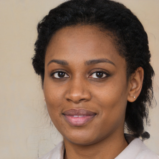 Joyful black young-adult female with medium  brown hair and brown eyes
