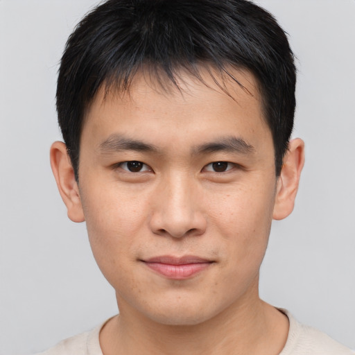 Joyful asian young-adult male with short  brown hair and brown eyes