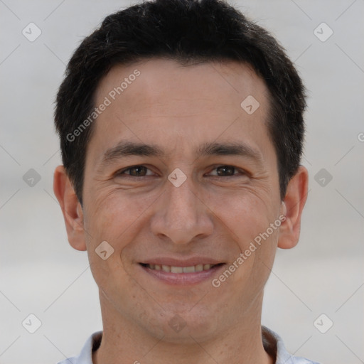 Joyful white adult male with short  brown hair and brown eyes