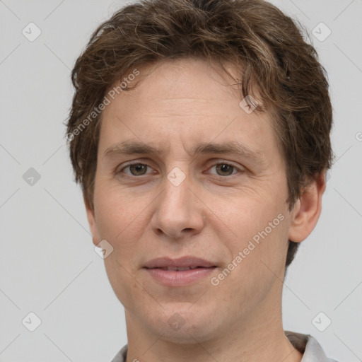 Joyful white adult male with short  brown hair and grey eyes