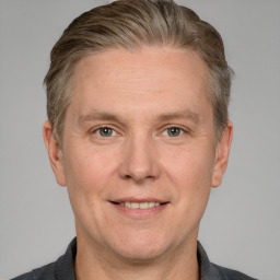 Joyful white adult male with short  brown hair and grey eyes