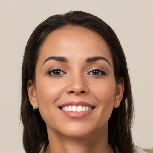 Joyful white young-adult female with long  brown hair and brown eyes