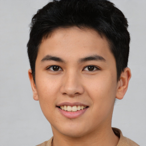 Joyful asian young-adult male with short  brown hair and brown eyes