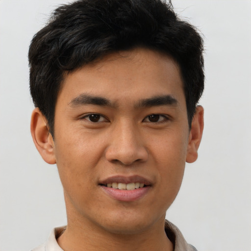 Joyful asian young-adult male with short  brown hair and brown eyes