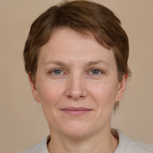 Joyful white adult female with short  brown hair and grey eyes