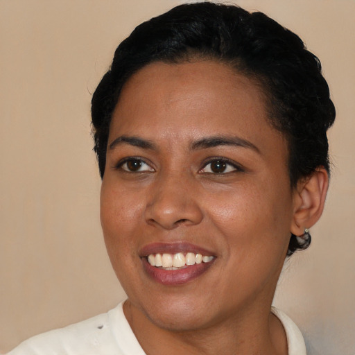 Joyful black young-adult female with short  black hair and brown eyes