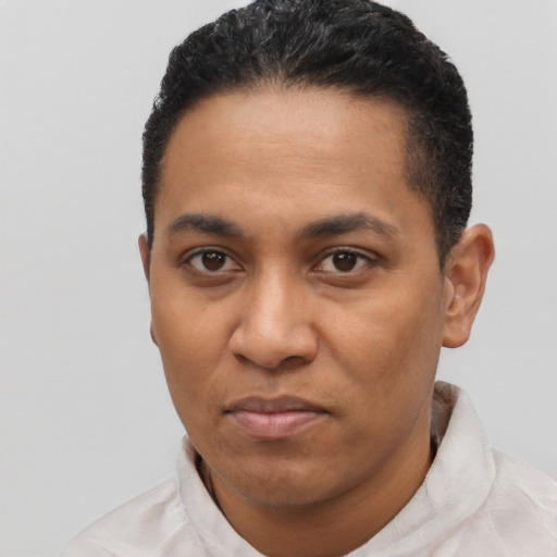 Joyful black young-adult male with short  black hair and brown eyes