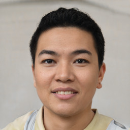 Joyful asian young-adult male with short  black hair and brown eyes