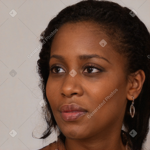 Neutral black young-adult female with long  brown hair and brown eyes