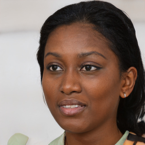 Joyful black young-adult female with medium  black hair and brown eyes