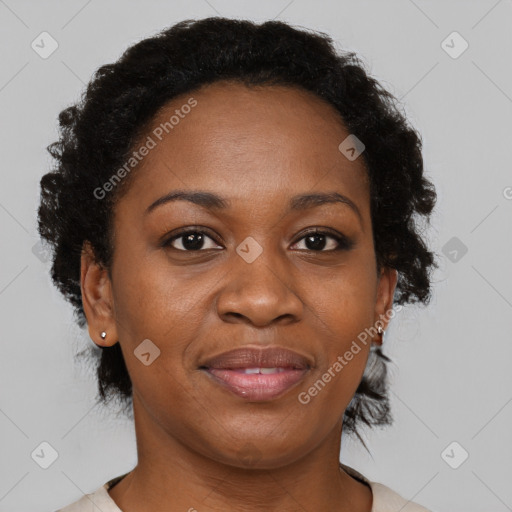 Joyful black adult female with short  brown hair and brown eyes