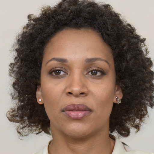 Neutral black adult female with medium  brown hair and brown eyes