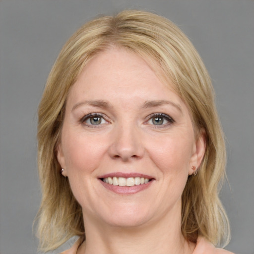 Joyful white young-adult female with medium  brown hair and blue eyes