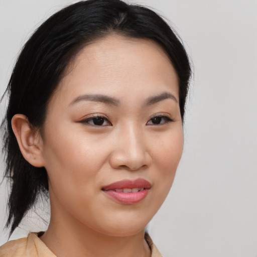 Joyful asian young-adult female with medium  brown hair and brown eyes