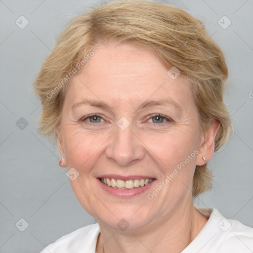 Joyful white adult female with medium  brown hair and blue eyes