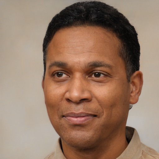 Joyful latino adult male with short  black hair and brown eyes