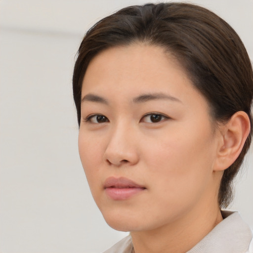 Neutral asian young-adult female with medium  brown hair and brown eyes