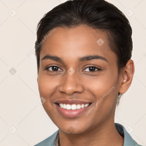 Joyful latino young-adult female with short  brown hair and brown eyes