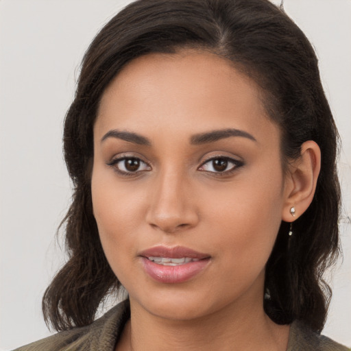 Joyful white young-adult female with long  brown hair and brown eyes