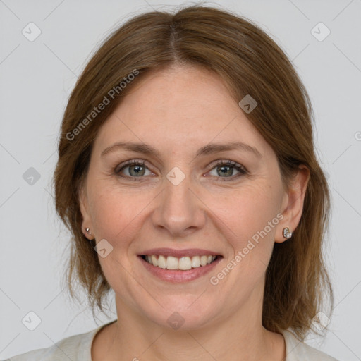 Joyful white adult female with medium  brown hair and grey eyes