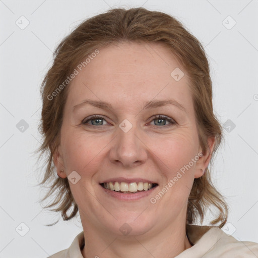 Joyful white adult female with medium  brown hair and blue eyes