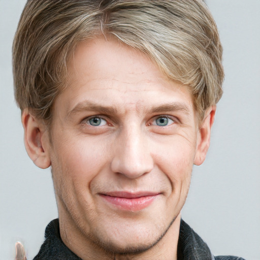 Joyful white adult male with short  brown hair and blue eyes