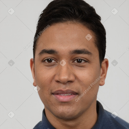 Joyful white young-adult male with short  black hair and brown eyes