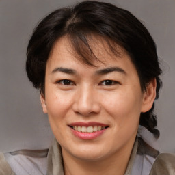 Joyful asian adult female with medium  brown hair and brown eyes